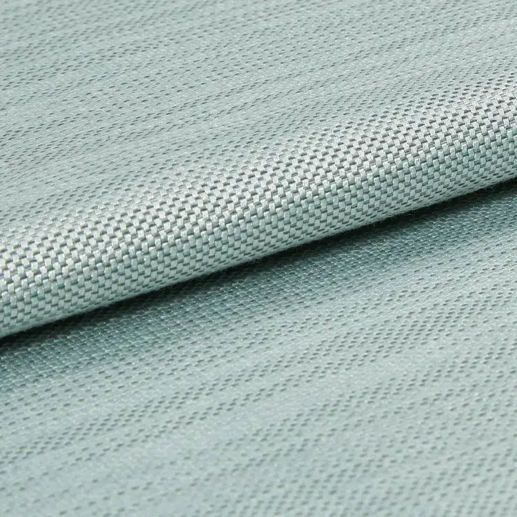 Close-up of light blueteal woven silky fabric.