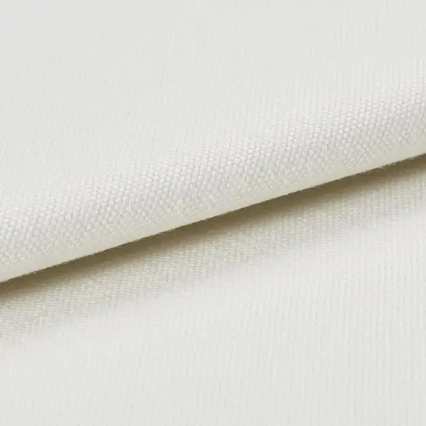 Close-up of textured off-white or cream fabric.