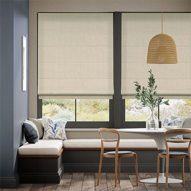 Cream Roman shades above a sunlit breakfast nook