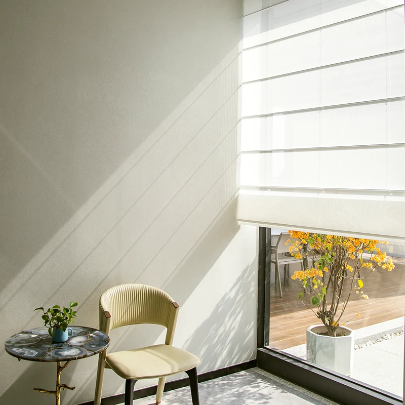 White semi-sheer Roman shade in a minimalist corner