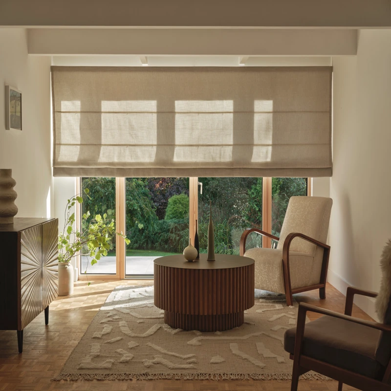 Wide linen Roman shade in a warm, mid-century room