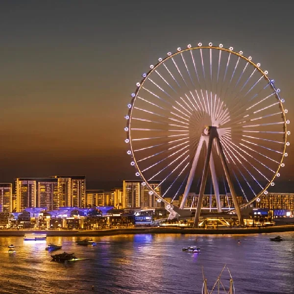 Ain Dubai Ferris wheel illuminated at dusk with city lights