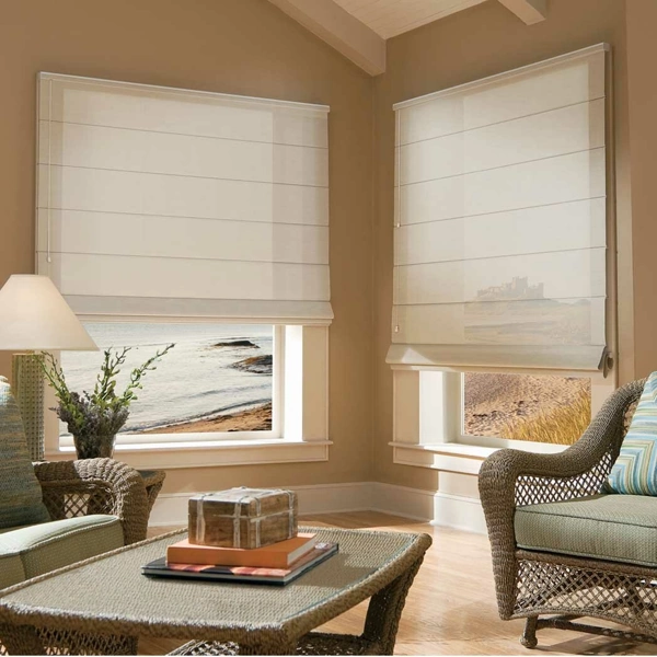 Custom white Roman blinds installed on beige living room windows