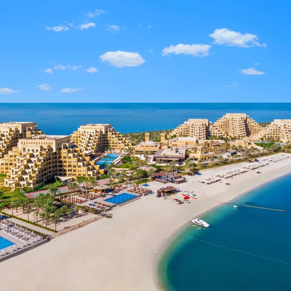 Luxury resort with pyramid-shaped buildings and beach