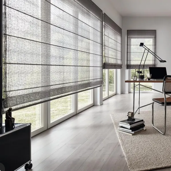 Textured grey Roman blinds in a modern home office