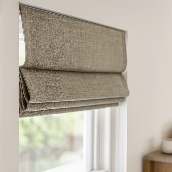 Textured taupe Roman blinds with soft folds